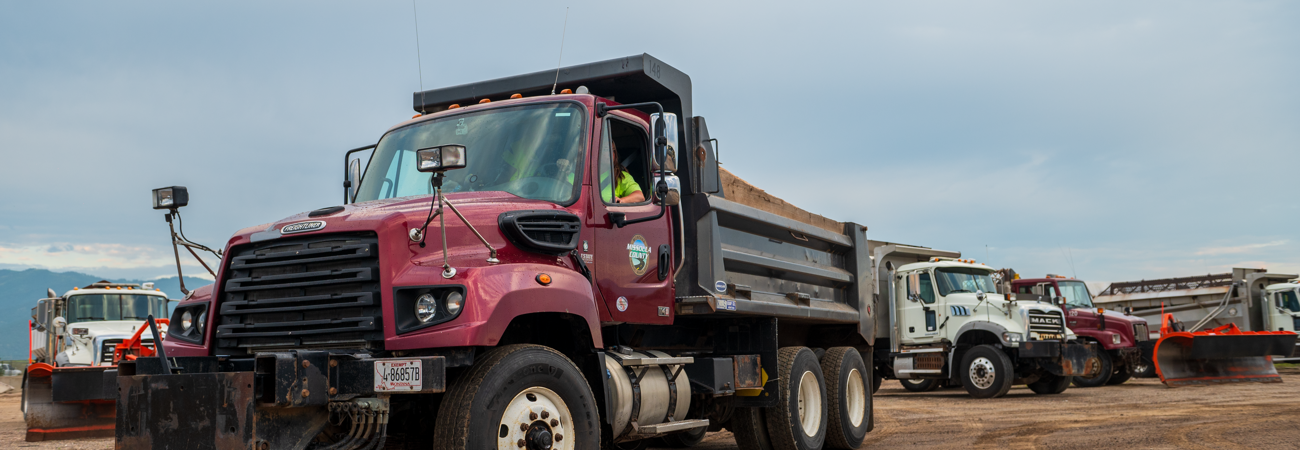 Public Works staff driving maintenance trucks