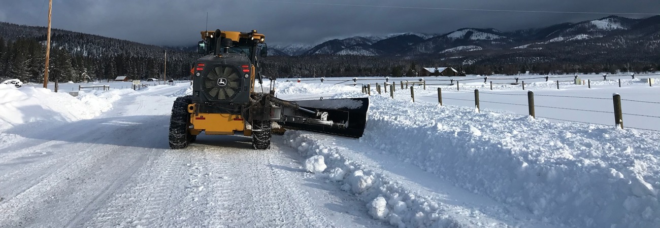 Snow plow on a rural road in winter