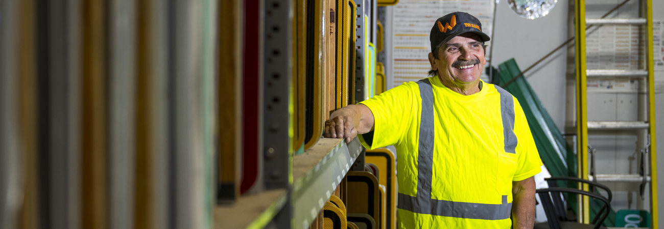 Smiling Public Works employee in the sign shop