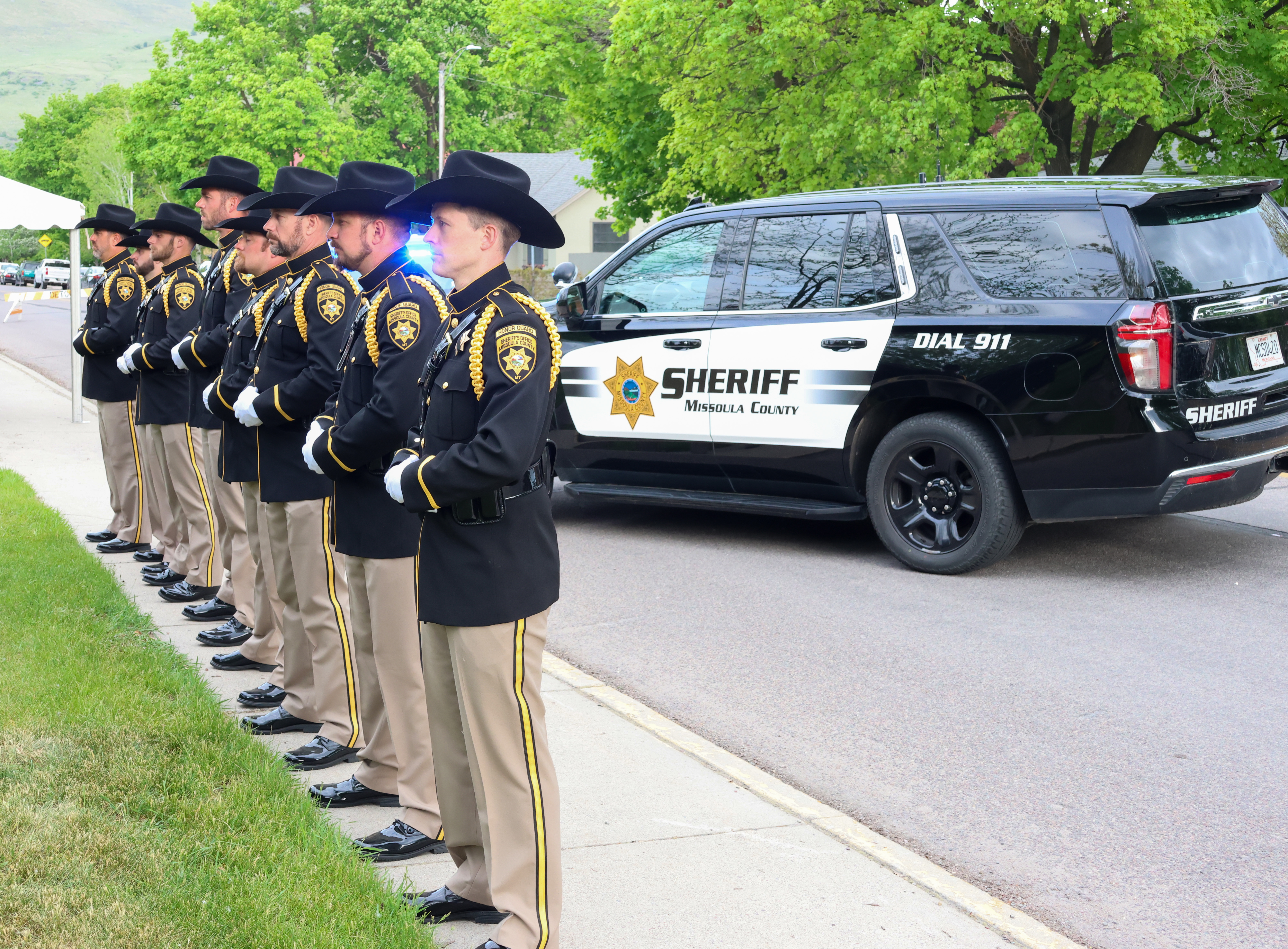 Honor Guard at attention with patrol car