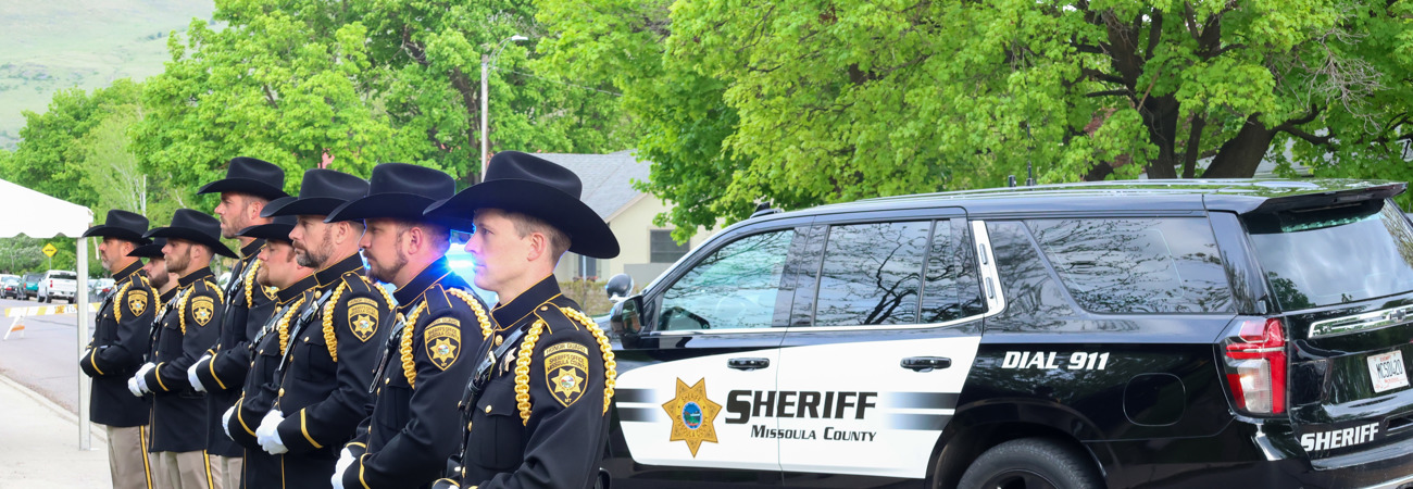 Honor Guard at attention with patrol car