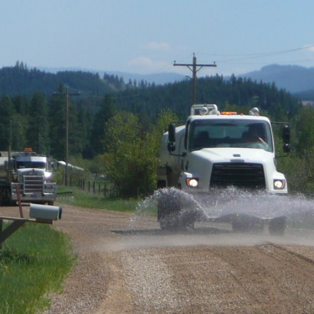 Dust Abatement Truck On A Sunny Day Gravel Road